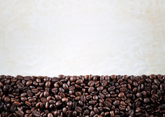 Obraz na płótnie Canvas Coffee beans on the paper background