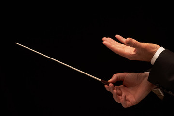 Concert conductor hands with baton
