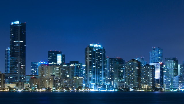 Time lapse of Miami skyline at night - slow pan to the right