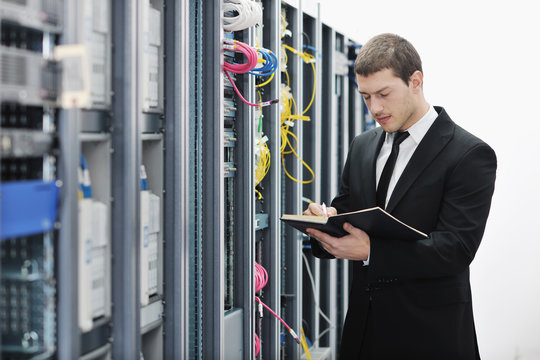 it businessman withnotebook in network server room