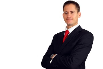 Handsome young business man smiling with his arms crossed