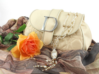 still life with handbag, rose and necklace
