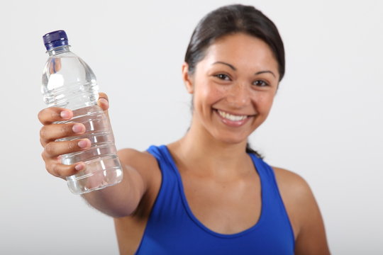 Bottle water held by beautiful smiling young woman