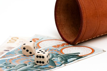 Two dices and some danish money on a white background