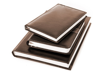 Three black notebooks on white background