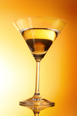 Martini glass on yellow background