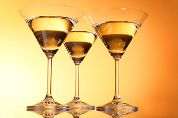 Three martini glasses on yellow background