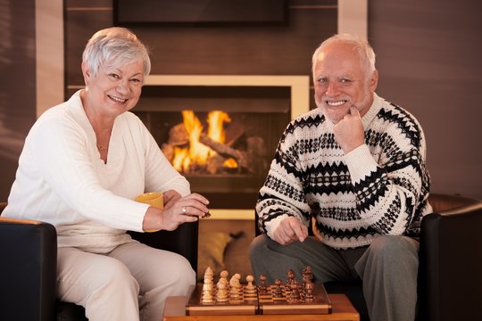 Portrait of elderly couple playing chess
