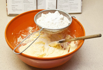Baking bread in orange bowl mixing flour
