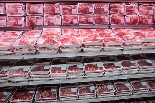 Fully loaded shelves with meat in large supermarket