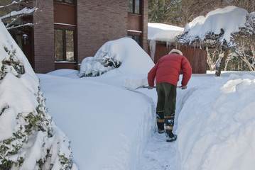 Man shoveling snow after a storm