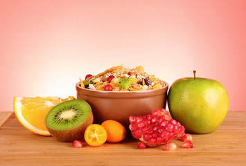 muesli and fruits on red background