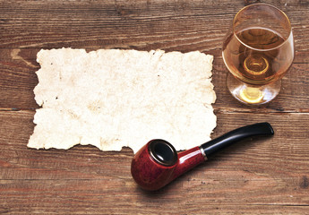 old paper, pipe and glass of cognac