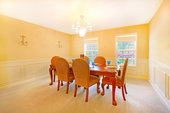 Yellow dining room with antique furniture