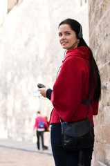 Young woman with headphones, listening to audio guide