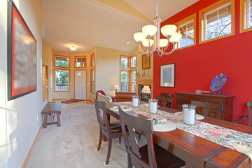 Large red living room with dark brown wood table