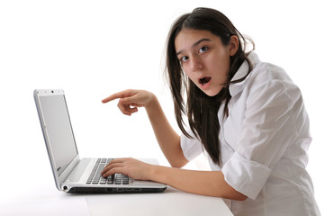 Teen girl pointing out laptop isolated on white background.