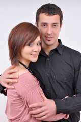 Woman and man posing on a grey background