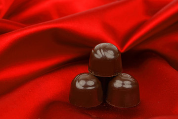 chocolate candy on red satin