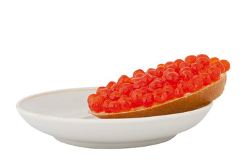 Bread with red caviar on plate on white background