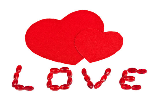 The inscription "Love" and two red textile hearts