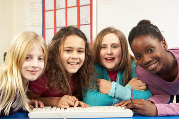 Group Of Schoolgirls In IT Class Using Computer