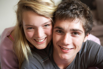Romantic Teenage Couple Smiling At Camera