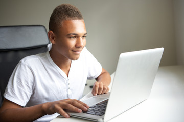 Teenage Boy Using Laptop At Home