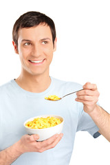 A young man eating cornflakes