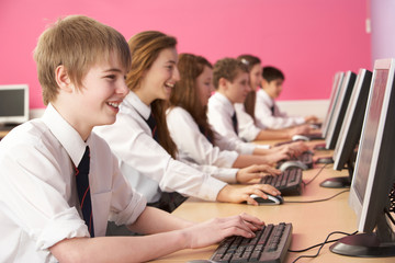 Teenage Students In IT Class Using Computers In Classroom