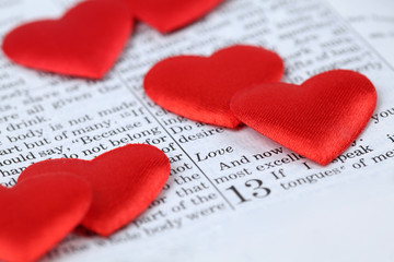 Bible open to 1st Corinthians 13 and heart shaped confetti