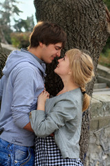 Young cheerful smiling couple in the park
