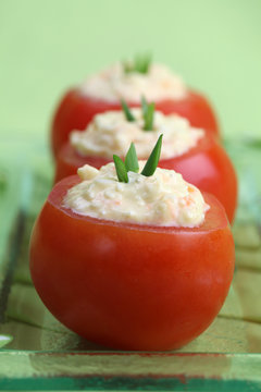 Tomatoes stuffed with cheese, egg and carrot spread