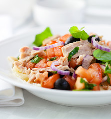 Delicious tuna salad with tomato,olives,fresh herbs and pasta