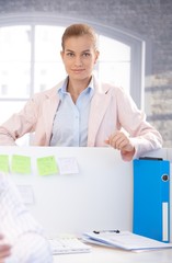 Portrait of attractive female smiling in office