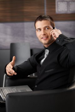 Goodlooking businessman chatting on phone