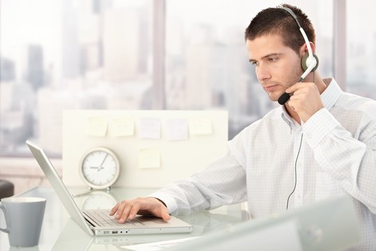 Customer service operator working in bright office