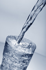 Fresh water pouring into a  glass