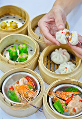 Steamed dumpling and dimsum with hand .