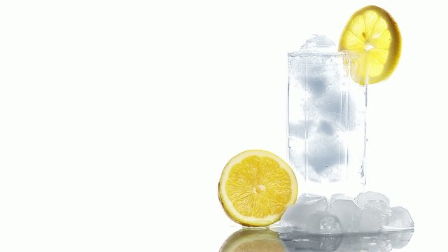 Cocktail In A Glass Adding Ice Tonic Water And A Slice Of Lime