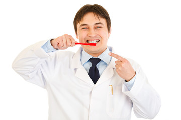 Dentist pointing finger on toothbrush. Concept - healthy teeth .