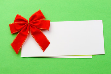 Red bow with card isolated on green