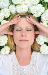 Young woman laying in flowers - snowballs