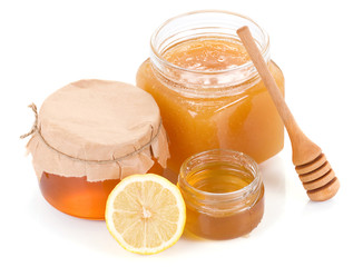 pot full of honey and lemon isolated on white