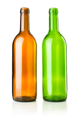 Two empty transparent green and brown wine bottles