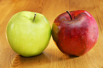 Red and green apples on table