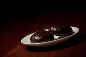 Chocolate zephyr sweets on a saucer
