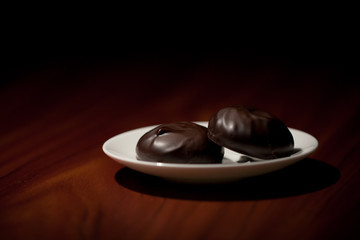 Chocolate zephyr sweets on a saucer