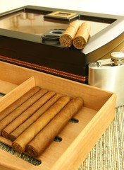 Cigars, cigar humidor, hip flask. Close up.