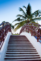 Staircase of the bridge under palm blue sky